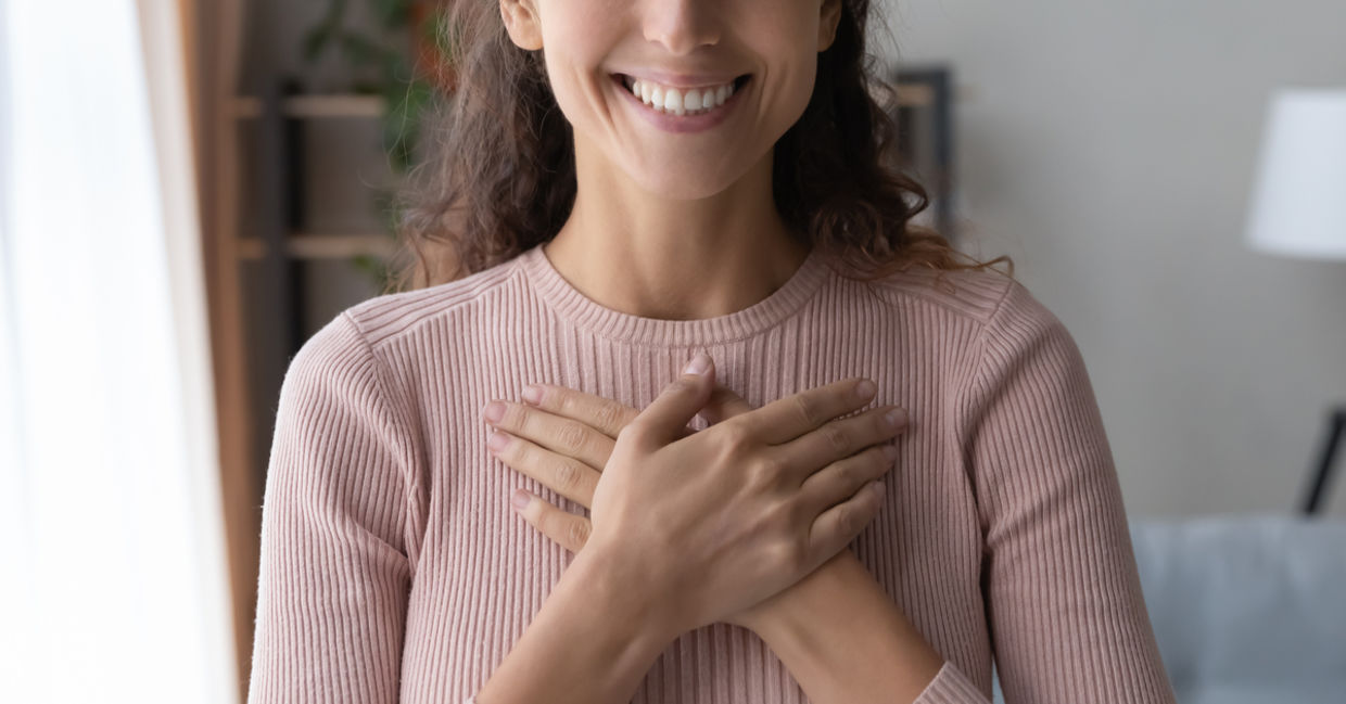 A woman smiles after receiving a compliment. A woman smiles after receiving a compliment.