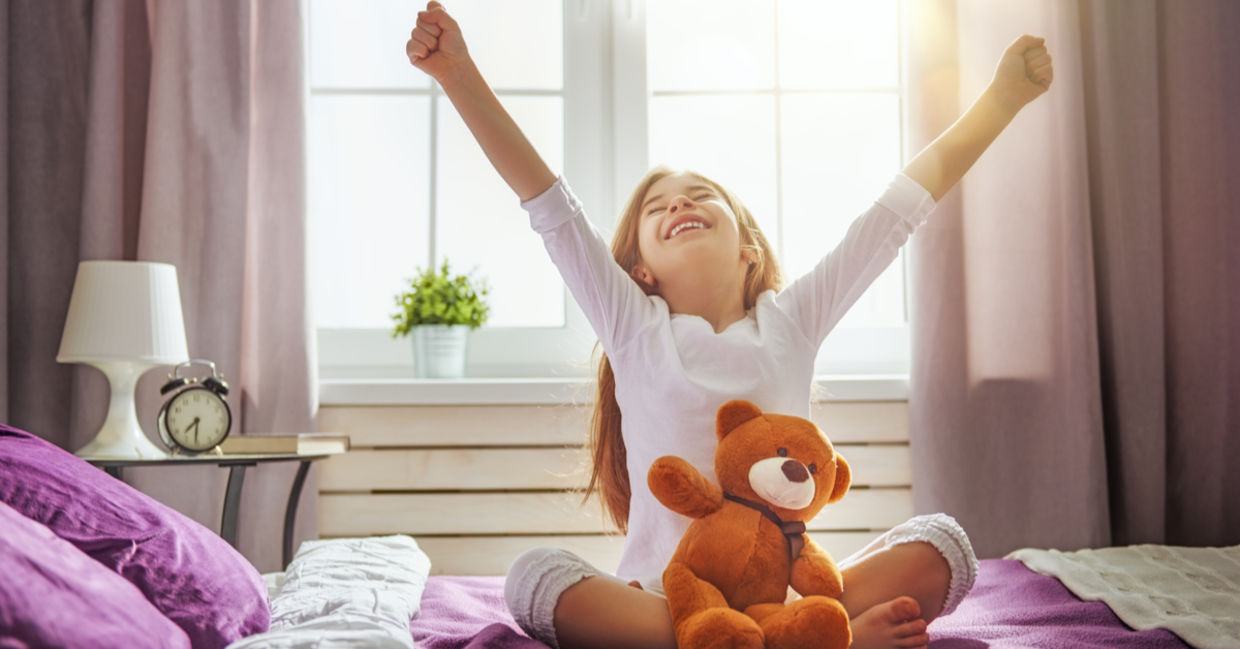 Young girl happily waking up and stretching. Young girl happily waking up and stretching.