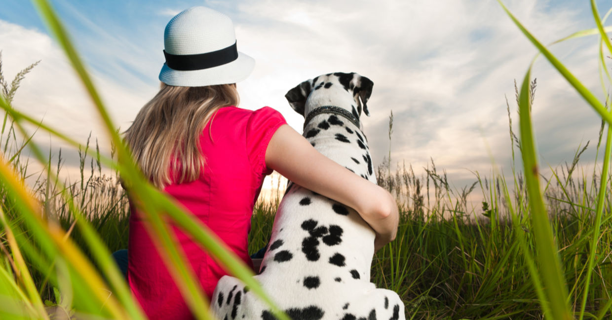 An animal empath lovingly hugs her Dalmatian dog. An animal empath lovingly hugs her Dalmatian dog.
