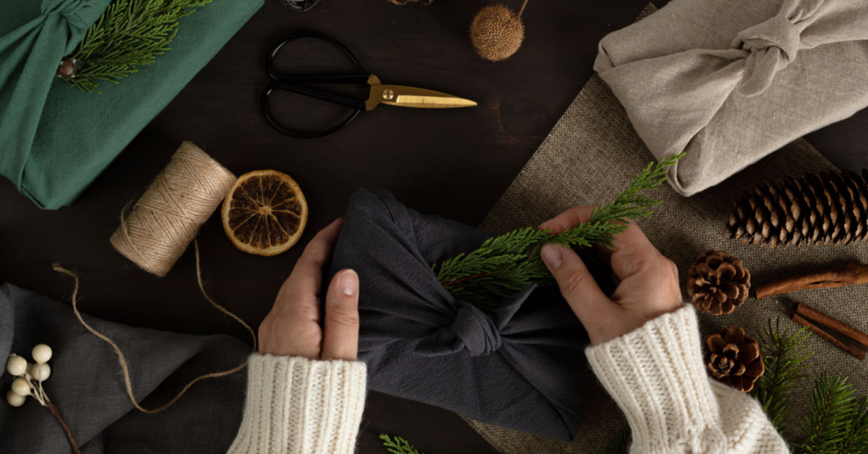 A woman wraps her presents furoshiki style, a nice environmentally-friendly option. A woman wraps her presents furoshiki style, a nice environmentally-friendly option.