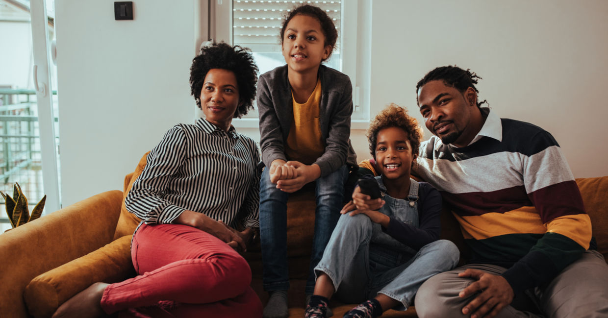 a family watching a movie together during Black History Month. a family watching a movie together during Black History Month.