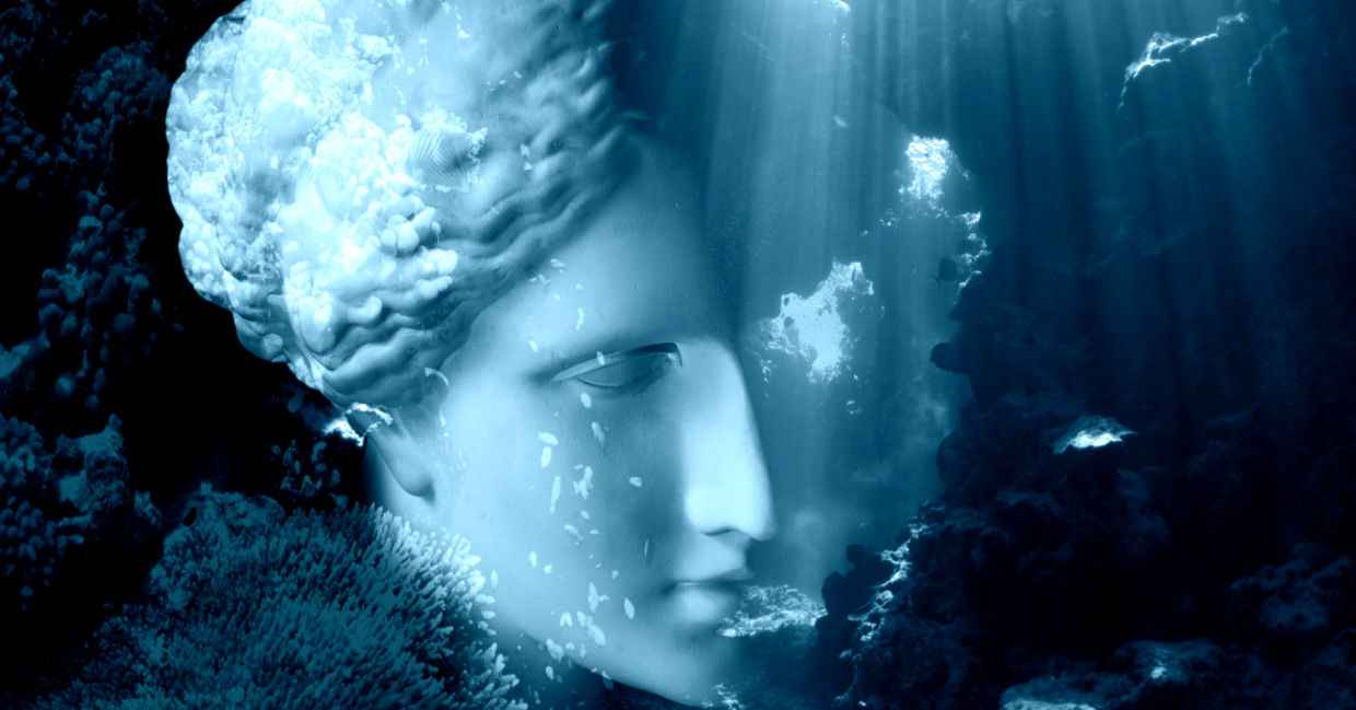 Face of ancient status on an underwater background with corals and fish. Face of ancient status on an underwater background with corals and fish.