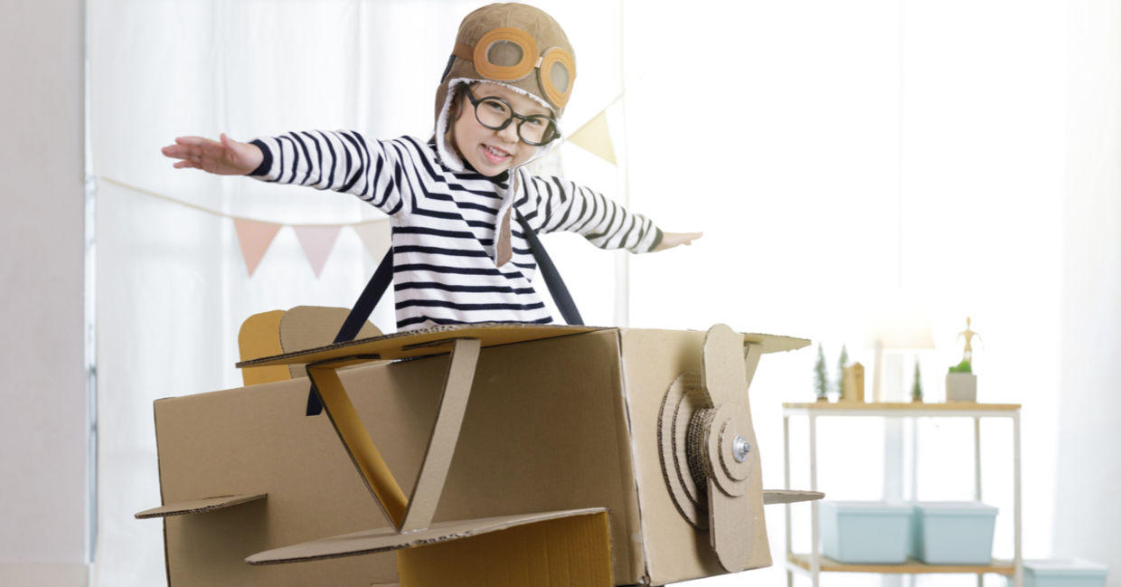 Creative little girl uses her imagination as she ‘flies’ in a cardboard box. Creative little girl uses her imagination as she ‘flies’ in a cardboard box.