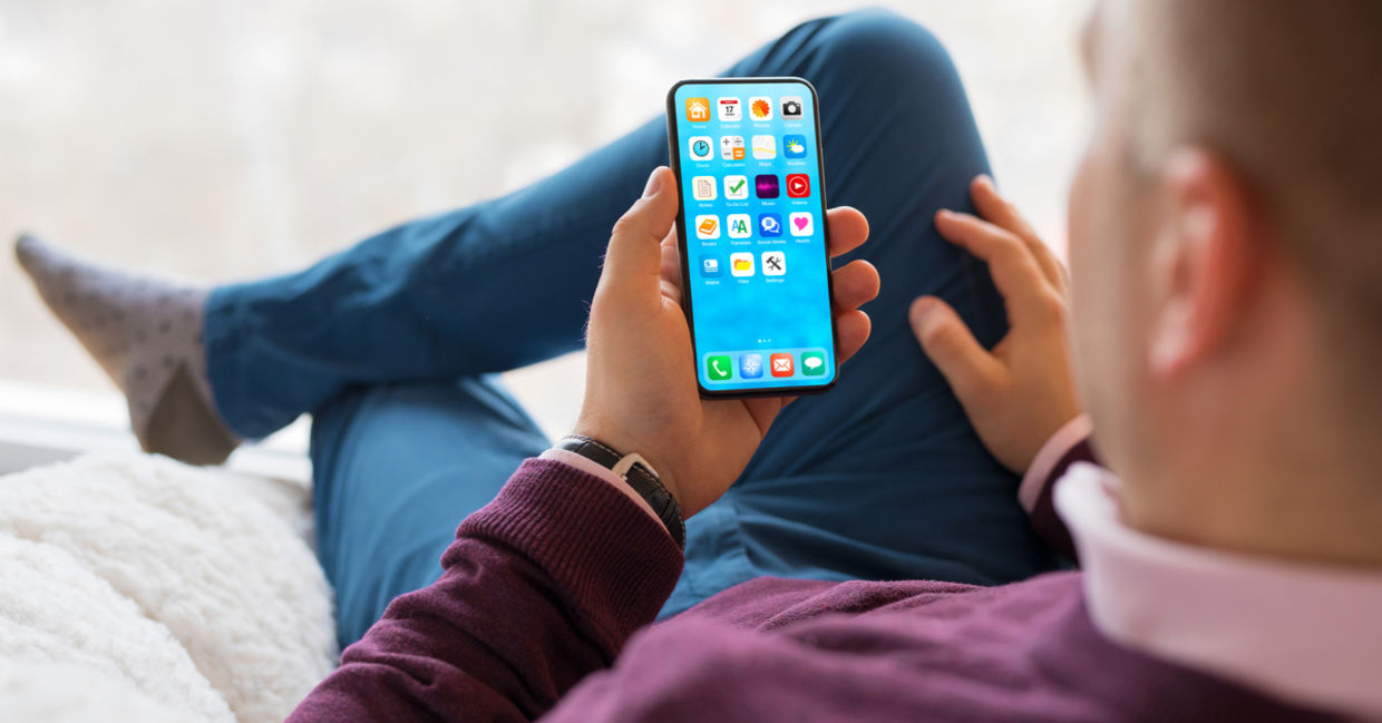 Man optimizing his smartphone homescreen. Man optimizing his smartphone homescreen.