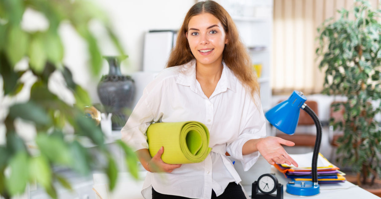 Happy young office worker with yoga mat. Happy young office worker with yoga mat.