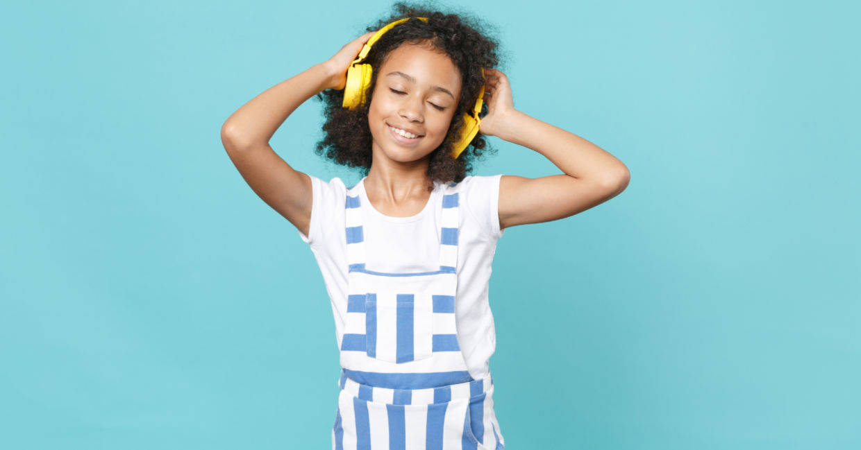 Cute kid enjoying music. Cute kid enjoying music.