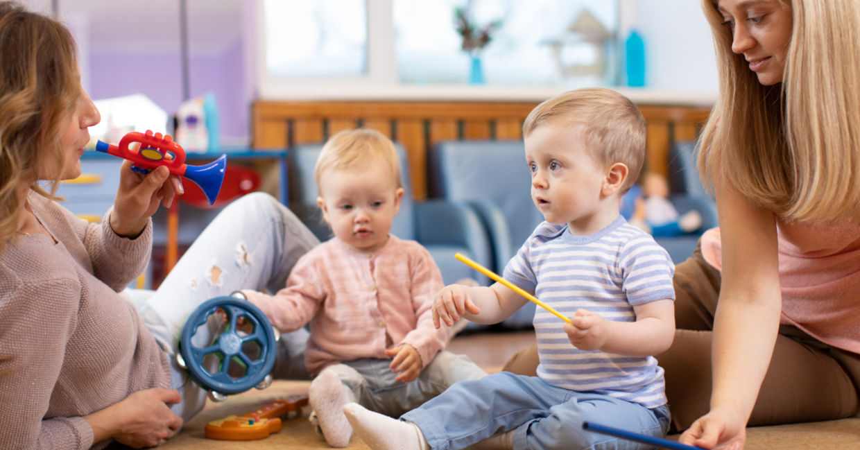 Preschoolers learning music with their parents. Preschoolers learning music with their parents.