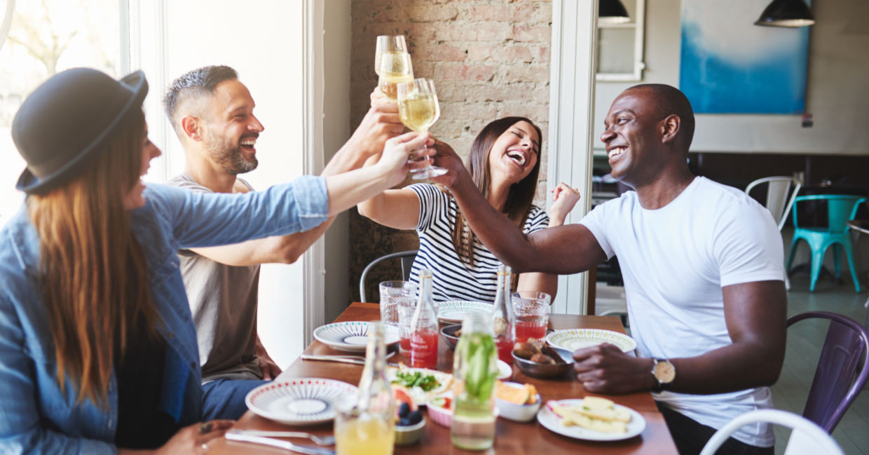 group of people eating a meal together group of people eating a meal together