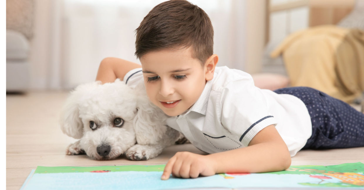 Little girl reading to her pet. Little girl reading to her pet.