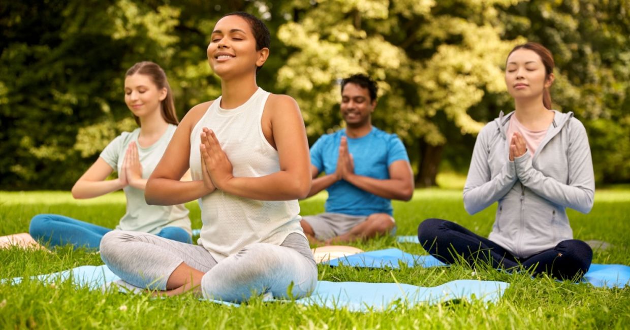 Meditating in a park. Meditating in a park.