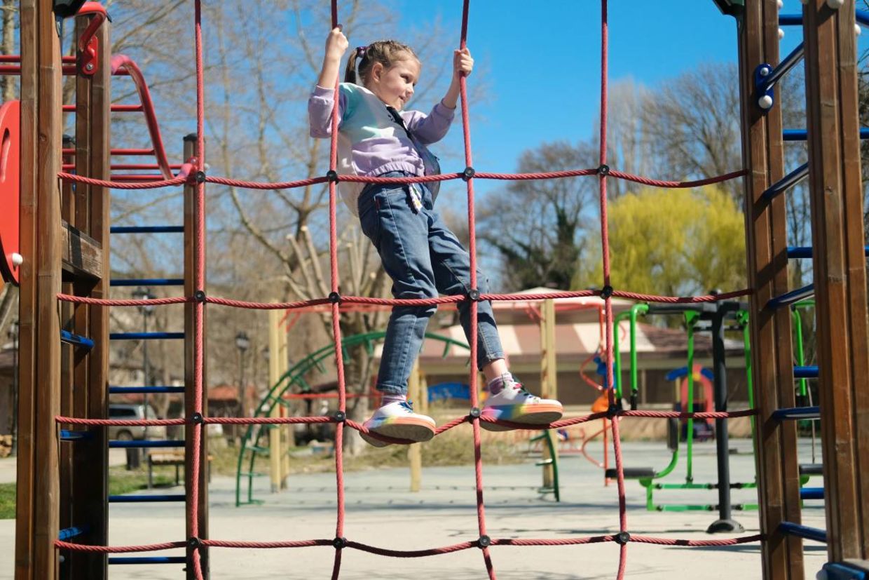 A child playing in an urban park. A child playing in an urban park.