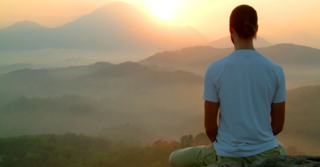 A man performing mindful meditation. A man performing mindful meditation.