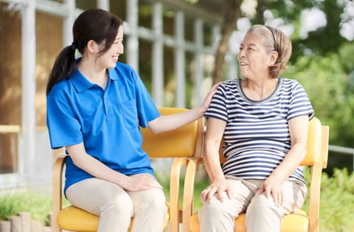 A young Japanese woman in a discussion with a grandma figure. A young Japanese woman in a discussion with a grandma figure.